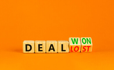 Deal lost or won symbol. Businessman turns wooden cubes and changes words Deal lost to Deal won. Beautiful orange table orange background, copy space. Business and deal lost or won concept.