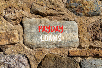 Payday loans symbol. Concept words Payday loans on beautiful big grey stone. Beautiful stone wall background. Business and Payday loans concept. Copy space.