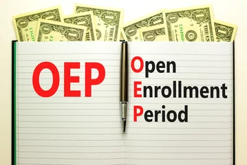 Deurstickers OEP symbol. Concept words OEP Open enrollment period on beautiful white note. Dollar bills. Beautiful white table white background. Medical and OEP Open enrollment period concept. Copy space. © Dzmitry