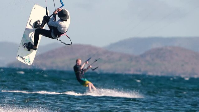 Sportsman practicing kite surf sport at the beach on a windy day at the Spanish coasts
