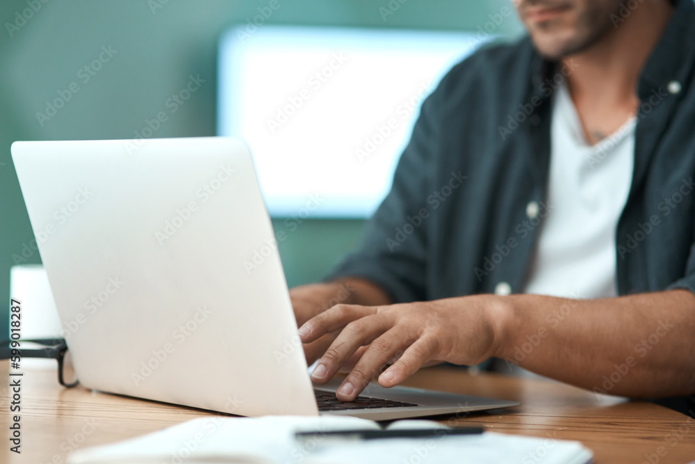 Poster working from home is so convenient. an unrecognizable man doing paperwork while using a laptop at ho