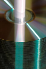 Close-up view of a stack of CDs or DVDs on a spindle