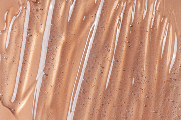 Drops and smears of cosmetics. Drops of liquid transparent gel with bubbles on a beige background.