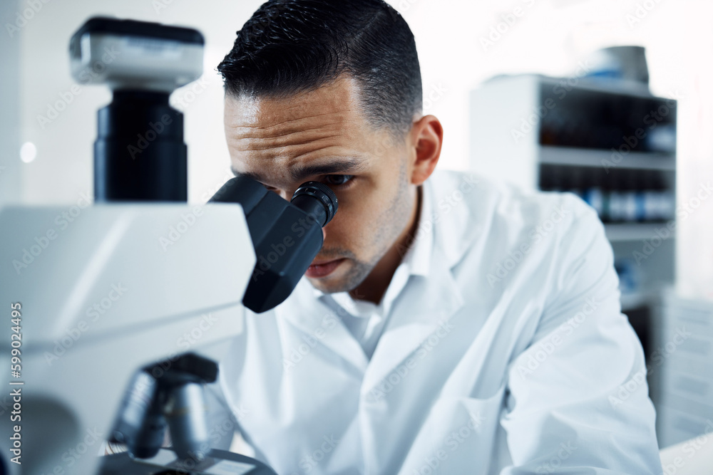 Aufkleber so close i can see everything. a young scientist using a microscope in a laboratory.