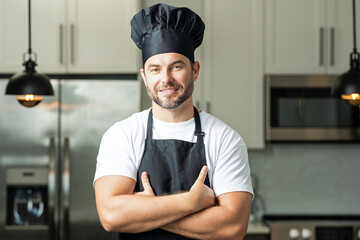 Man in chef apron cooking on kitchen.