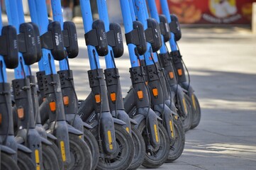 Scooters for rent, parking, no name, in a row, city, carsharing,