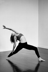 REverse warrior yoga pose. Black and white photography. 