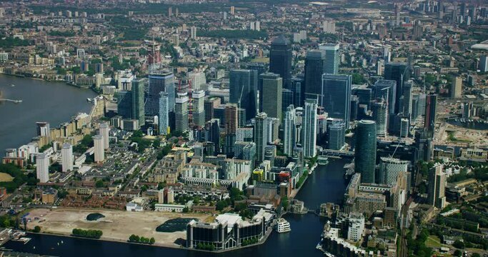 Canary Wharf aerial view with its moderns skyscrapers. This is one of the financial centers of London. Millwall Inner Dock. Train passing by South Quay station. Modern high rise buildings. England. UK