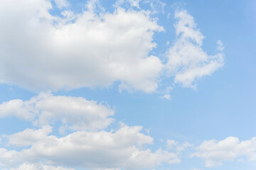 Obraz na płótnie Canvas White clouds on a blue sky background.