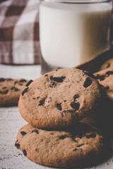 fresh healthy milk and cookies on white wood background