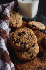 fresh healthy milk and cookies on dark wood background