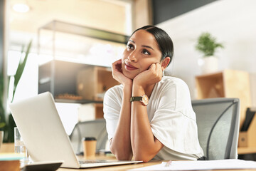 Fototapeta premium Dreaming of more exciting days. a young businesswoman day dreaming at her desk.