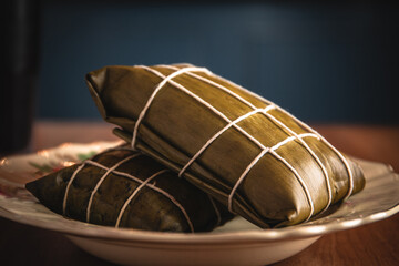Peruvian tamal, traditional breakfast wrapped in bananas leaves.