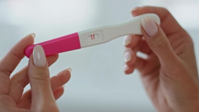 Lady hands pregnancy test holding at home closeup. Future maternity concept Generative AI