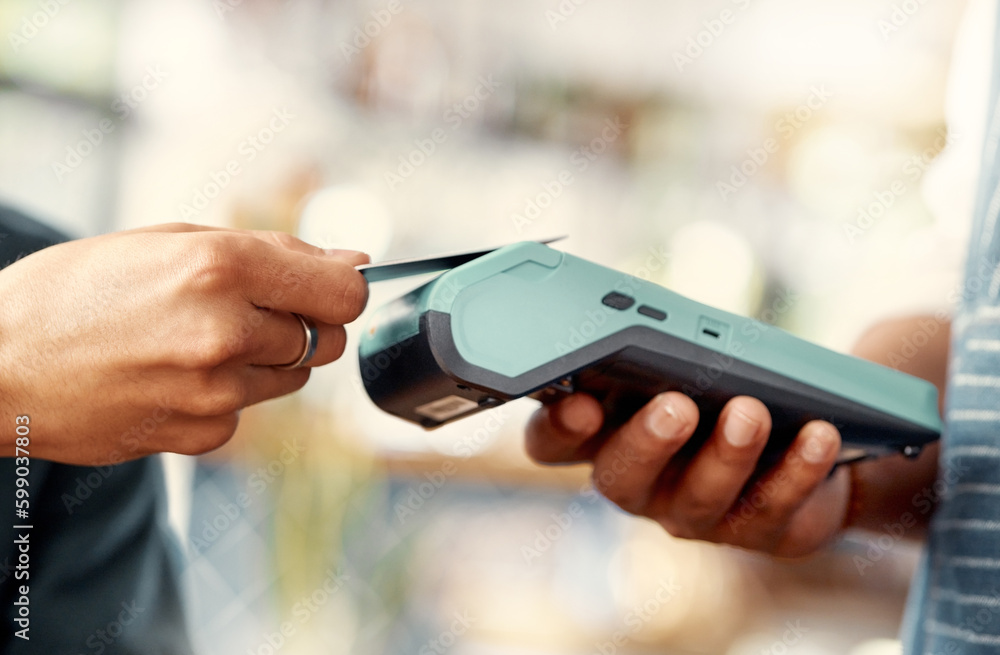 Poster spending money left and right. a man using a nfc machine to make a card payment at a restaurant.