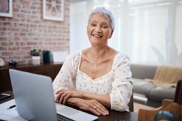 Online banking helps me stay in good financial shape. a senior woman using a laptop at home.