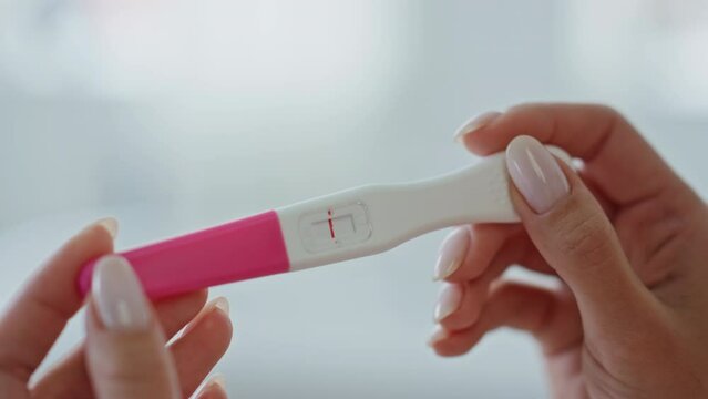Woman fingers pregnancy test making indoor closeup. Lady looking negative result Generative AI