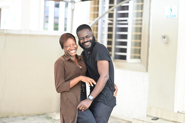 hug and enjoy black african race couple of model man and woman young 25 years old stay in love and touch joking and playing together. 