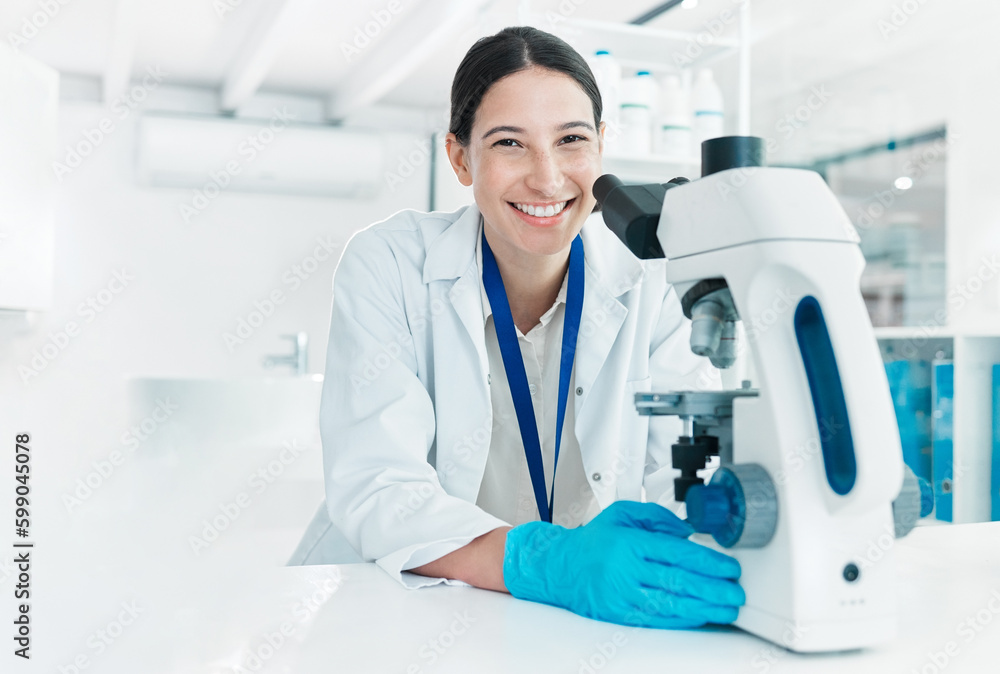 Poster im nearing the end of my research case. portrait of a young scientist using a microscope in a lab.