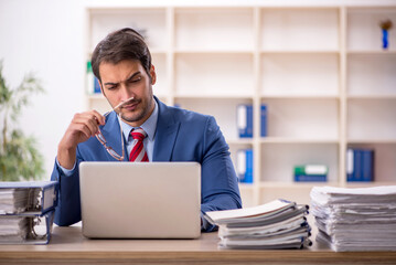 Young male employee working in the office