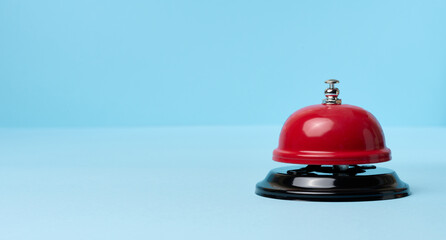 Metallic red bell to call staff on a blue background