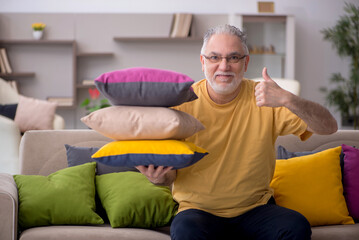 Old man with many pillows at home