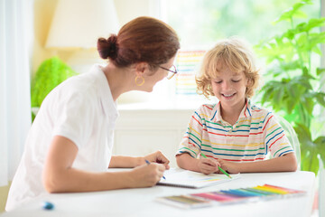 Fototapeta premium Child drawing. School kid painting a picture.