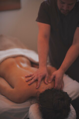 Photographs of massage and bodywork. Male therapist working on female client.  - 599054472