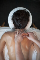 Photographs of massage and bodywork. Male therapist working on female client.  - 599054870