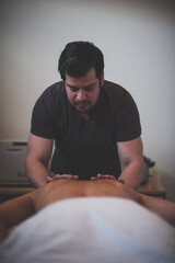 Photographs of massage and bodywork. Male therapist working on female client.  - 599055074