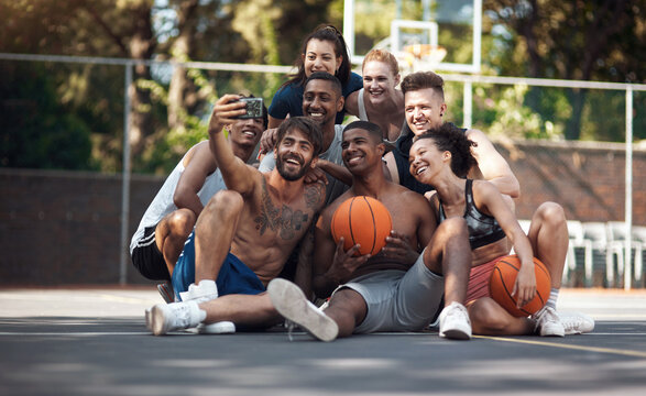 Sporting the biggest smiles on the court. a group of sporty young people taking selfies together on a sports court.