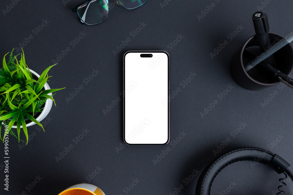 Poster phone mockup on black desk. isolated screen in white for app design promotion. top view, flat lay co