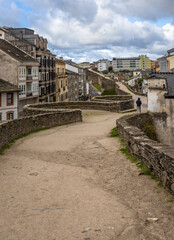 Fototapeta na wymiar Exposure from the Lugo city Walls, from where you can see the surrounding modern buildings, old gates and towers of this fortifications located in this Spanish city.