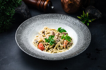 Lunch pasta with beef, tomatoes, parmesan and parsley.