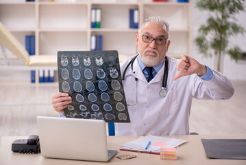 Obraz premium Old male doctor radiologist working in the clinic