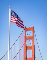 Fototapeta premium Golden Gate Bridge Tower and American Flag