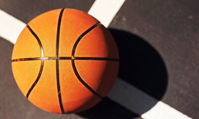 The ball is in your court. Still life shot of a basketball on the ground in a sports court.