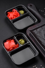 Pickled ginger, soy sauce and wasabi in portioned plastic containers