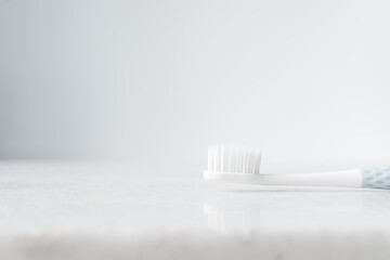Pastel blue toothbrush with white bristles on a white background, Pastel blue toothbrush with copy...