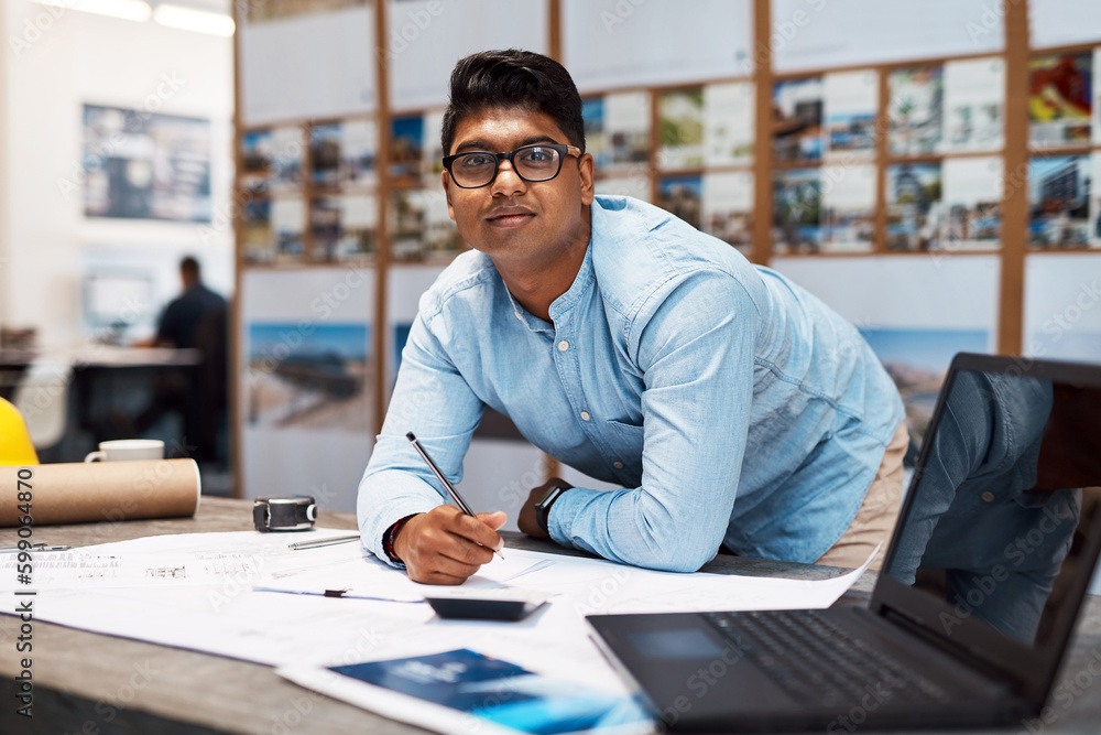 Poster Im committed to completing this project. a young architect drawing up a building plan in a modern office.