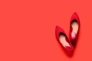 Pair of stylish female shoes on color background
