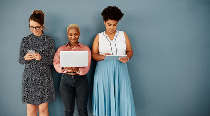 Youll need to byod to join them. Studio shot of a group of attractive young businesswomen using...