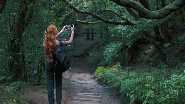 Woman is in an enchanted forest taking a selfie. Generative AI