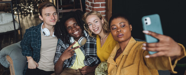 Cheerful group of diverse friends taking selfie. Young people international students have fun together, party, celebrate. African American, Caucasian multi cultural college university community banner