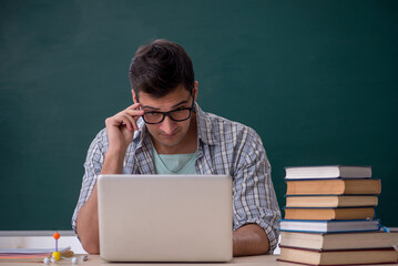 Young male student sitting in the classroom