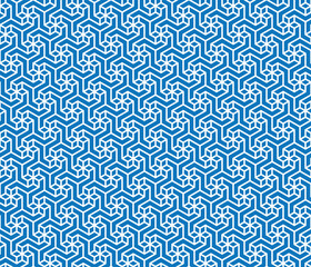 Seamless repeating pattern with geometric small white flowers on a blue background. Retro style ornamental maze. Traditional design.  Graphic textile texture. Vector illustration.