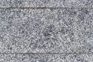 A close up of grey granite stone wall