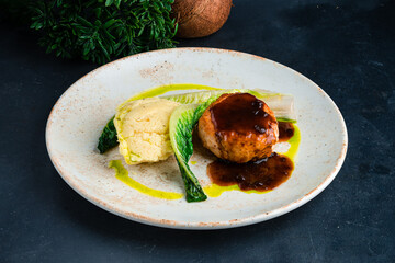 Lunch chicken cutlet with mashed potatoes, greens and sauce.