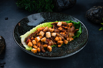 Lunch beef goulash with beans, cucumbers, onions and croutons in a lettuce leaf.