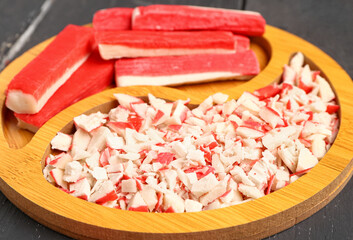 Plate with tasty chopped crab sticks on table, closeup © Pixel-Shot